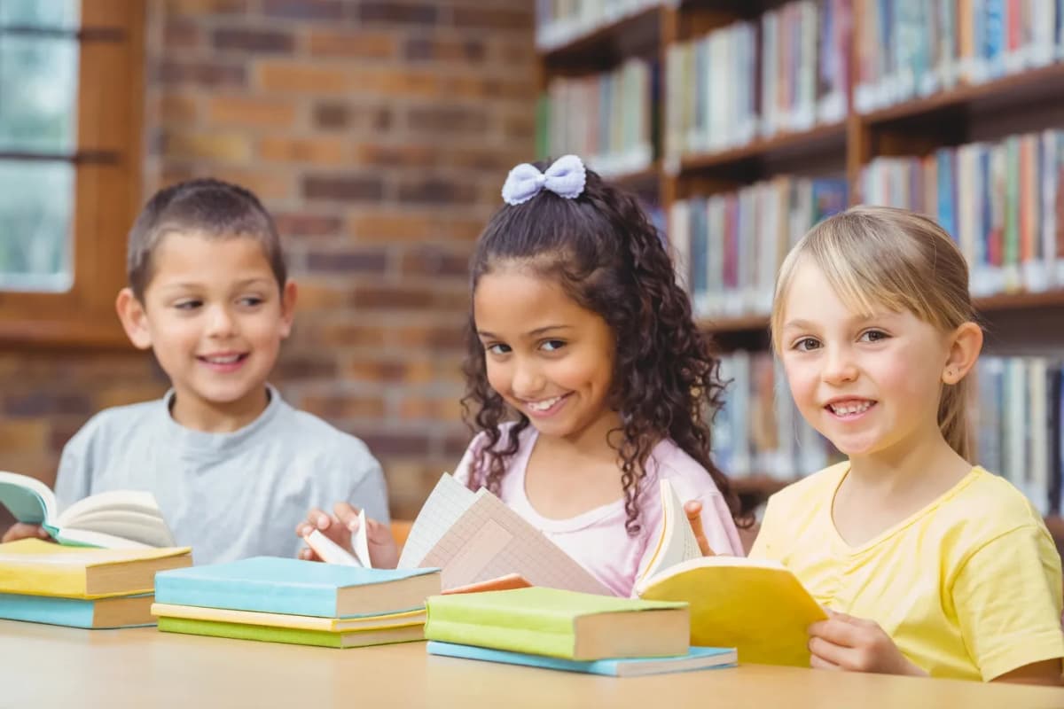 Children reading English books in a library